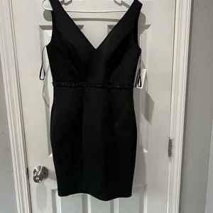 Never worn! Black short fitted formal dress with black beaded waist. Size 6